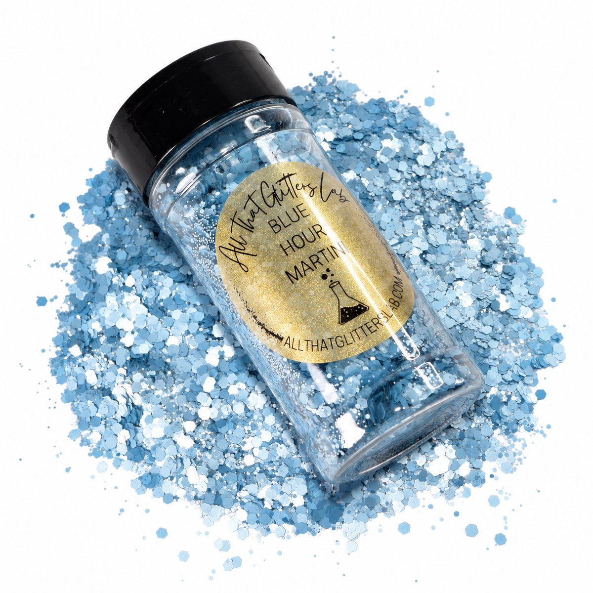 Blue Hour Martini shown in it's shaker on top of a pile of pale blue chunky mix glitter